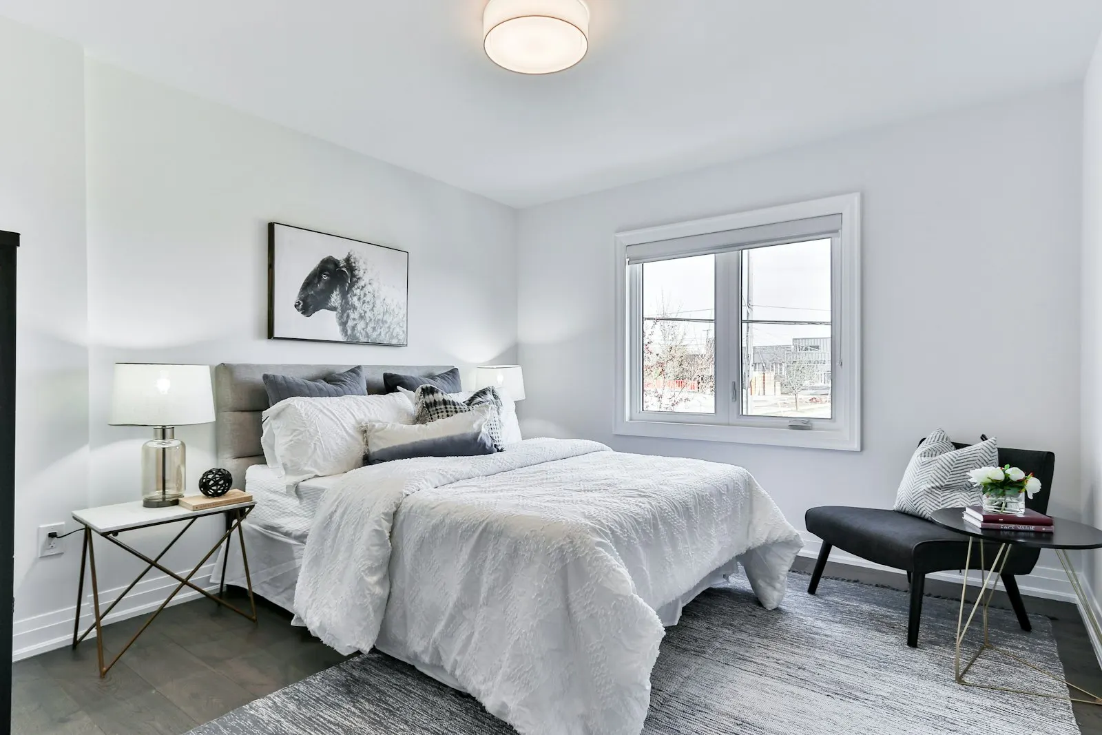 Bedroom with an exposed brick feature wall and crisp white bedding