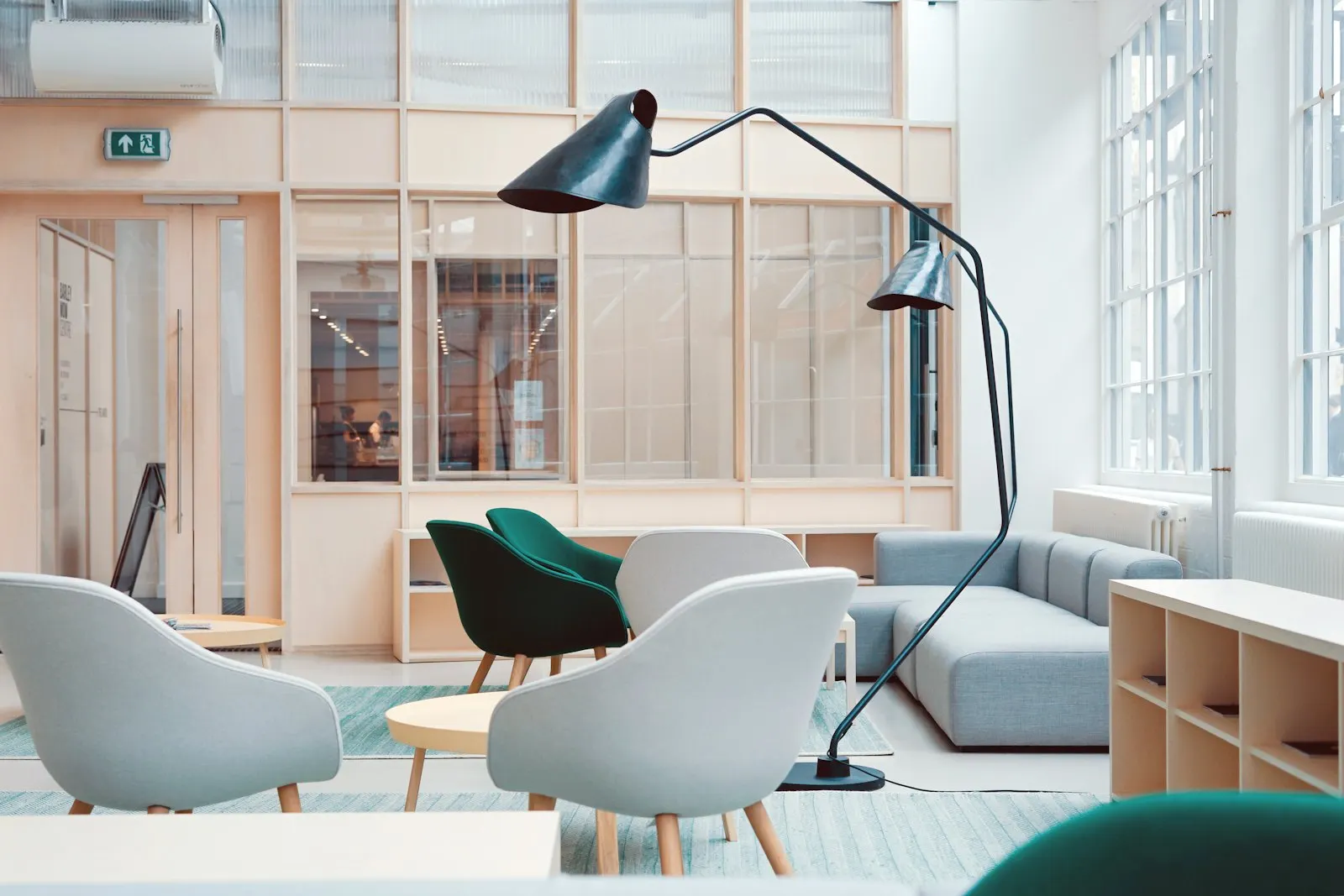 Reception lounge with a wood reception desk and soft blue visitor seating